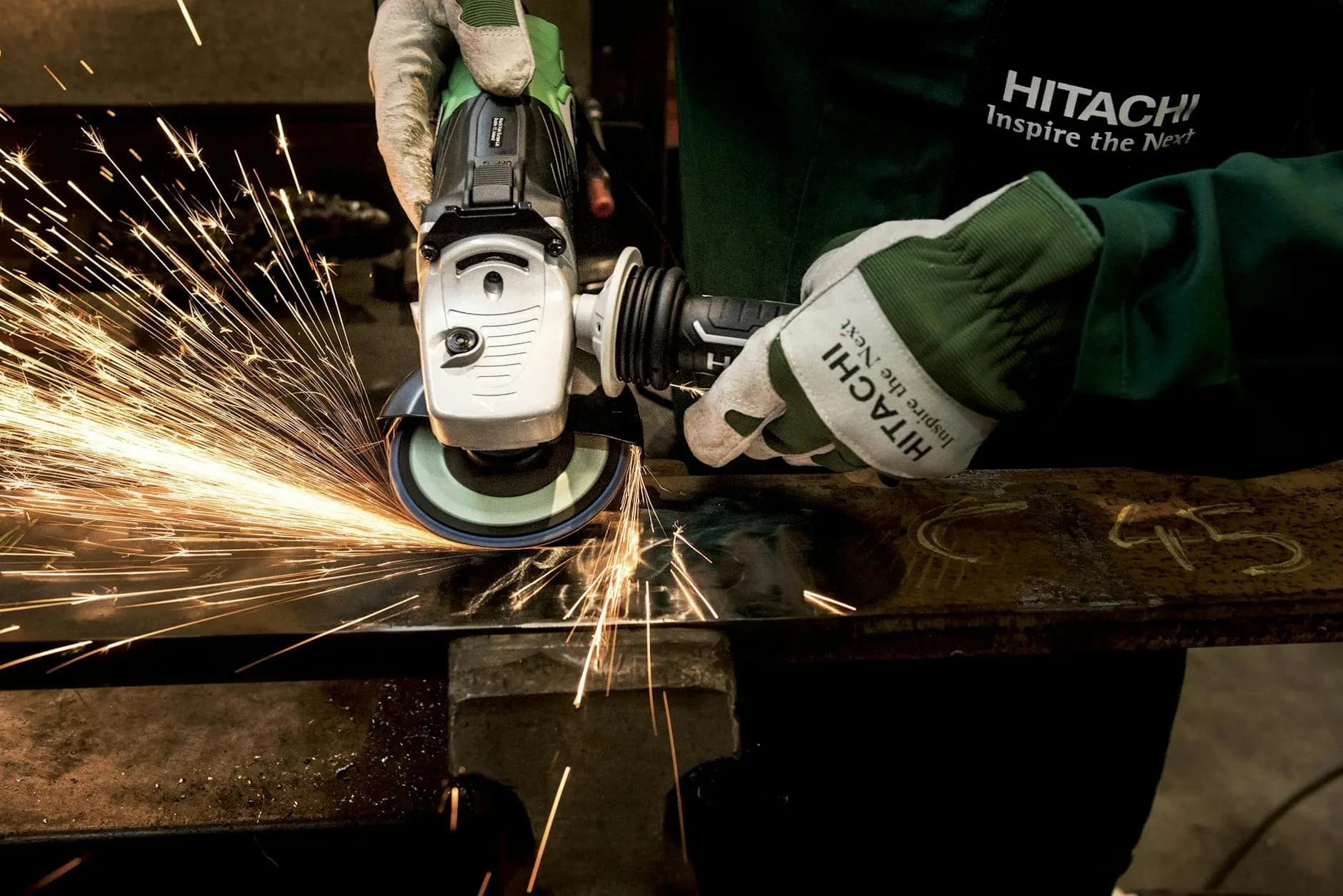 factory worker grinding steel